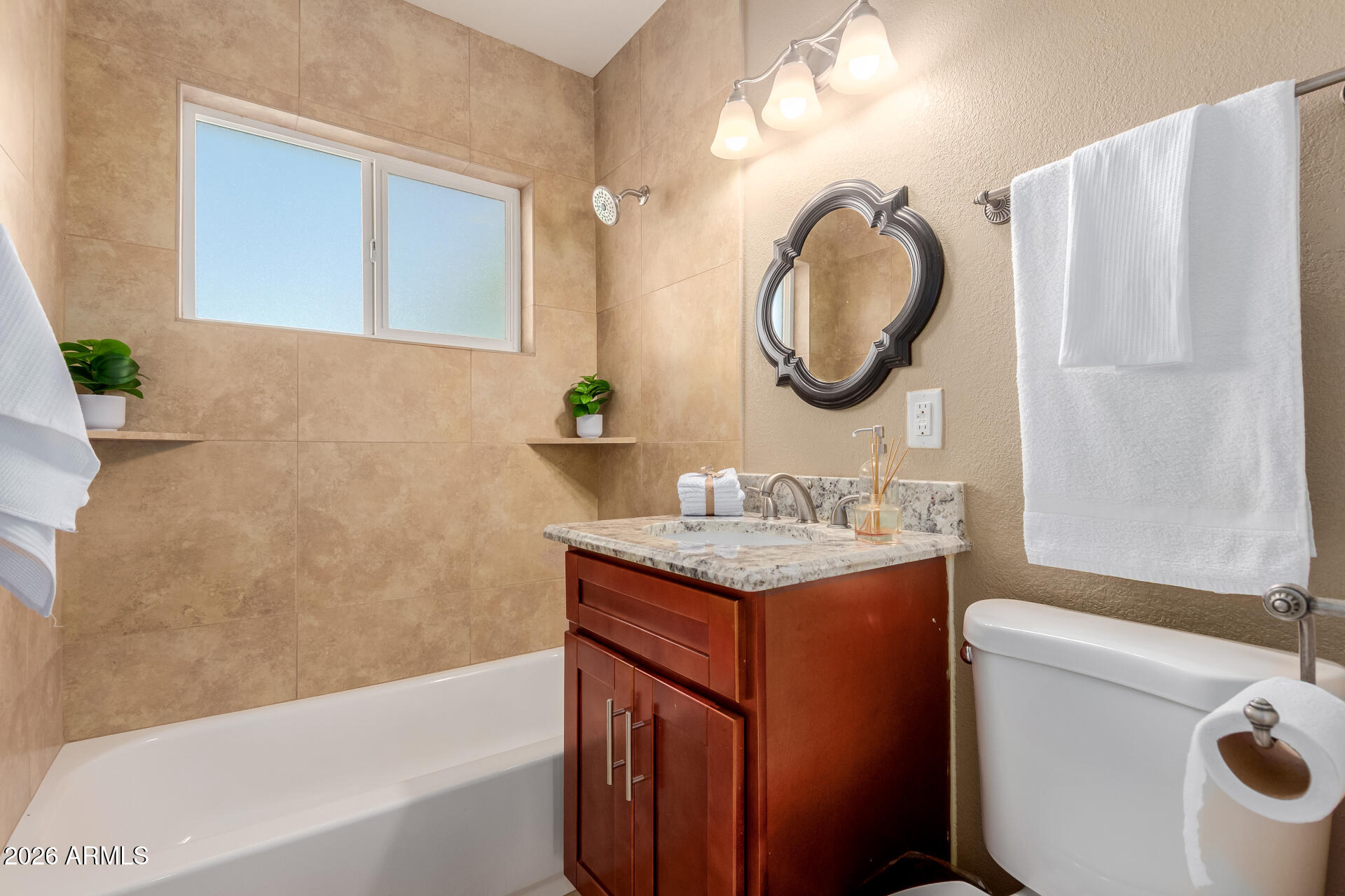 1644 West Sonora Street Phoenix, AZ 85007 - Photo 23 of 29 a bathroom with a granite countertop toilet sink and mirror