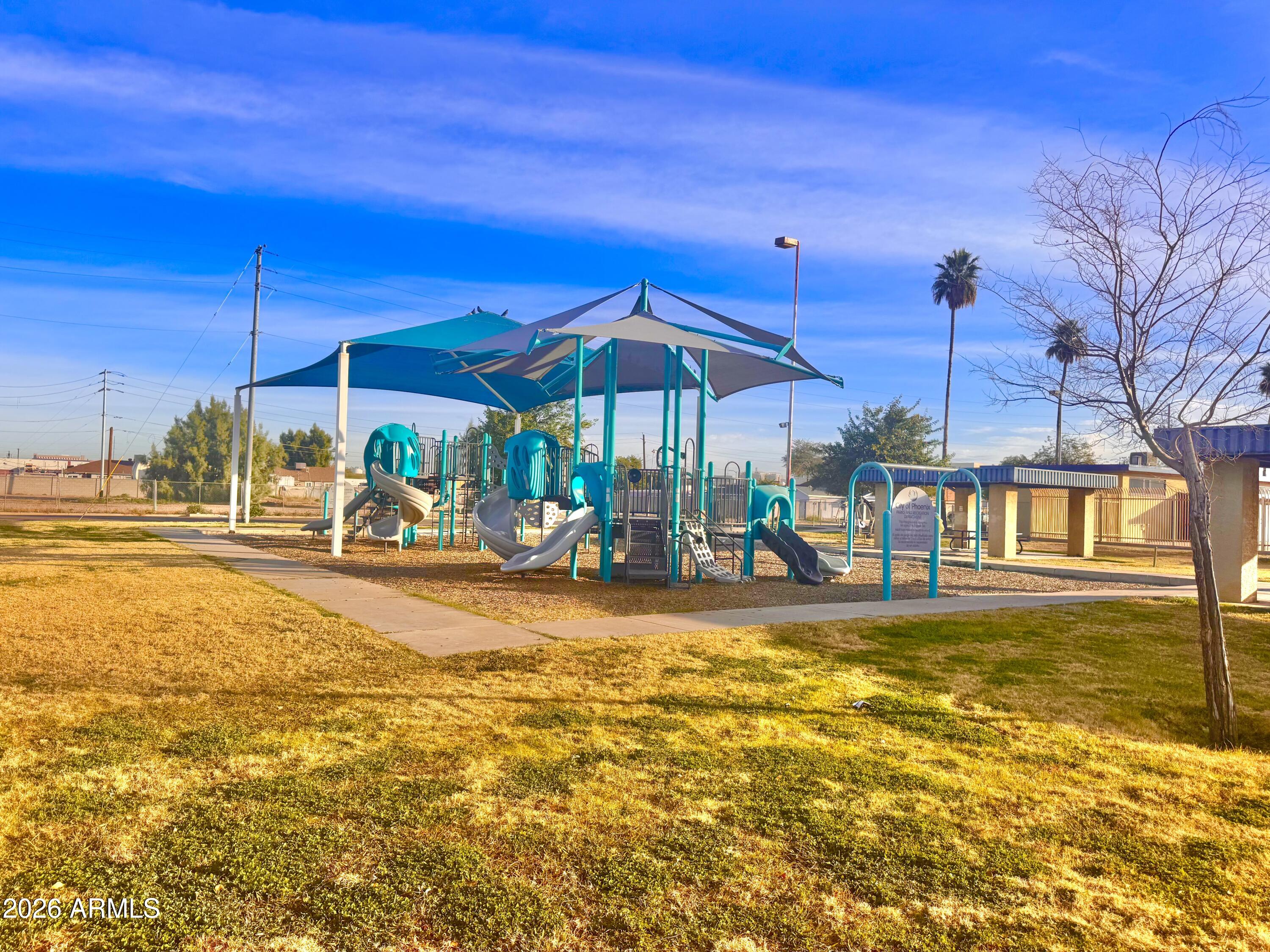 1644 West Sonora Street Phoenix, AZ 85007 - Photo 27 of 29 a view of a swimming pool with a lawn chairs under an umbrella