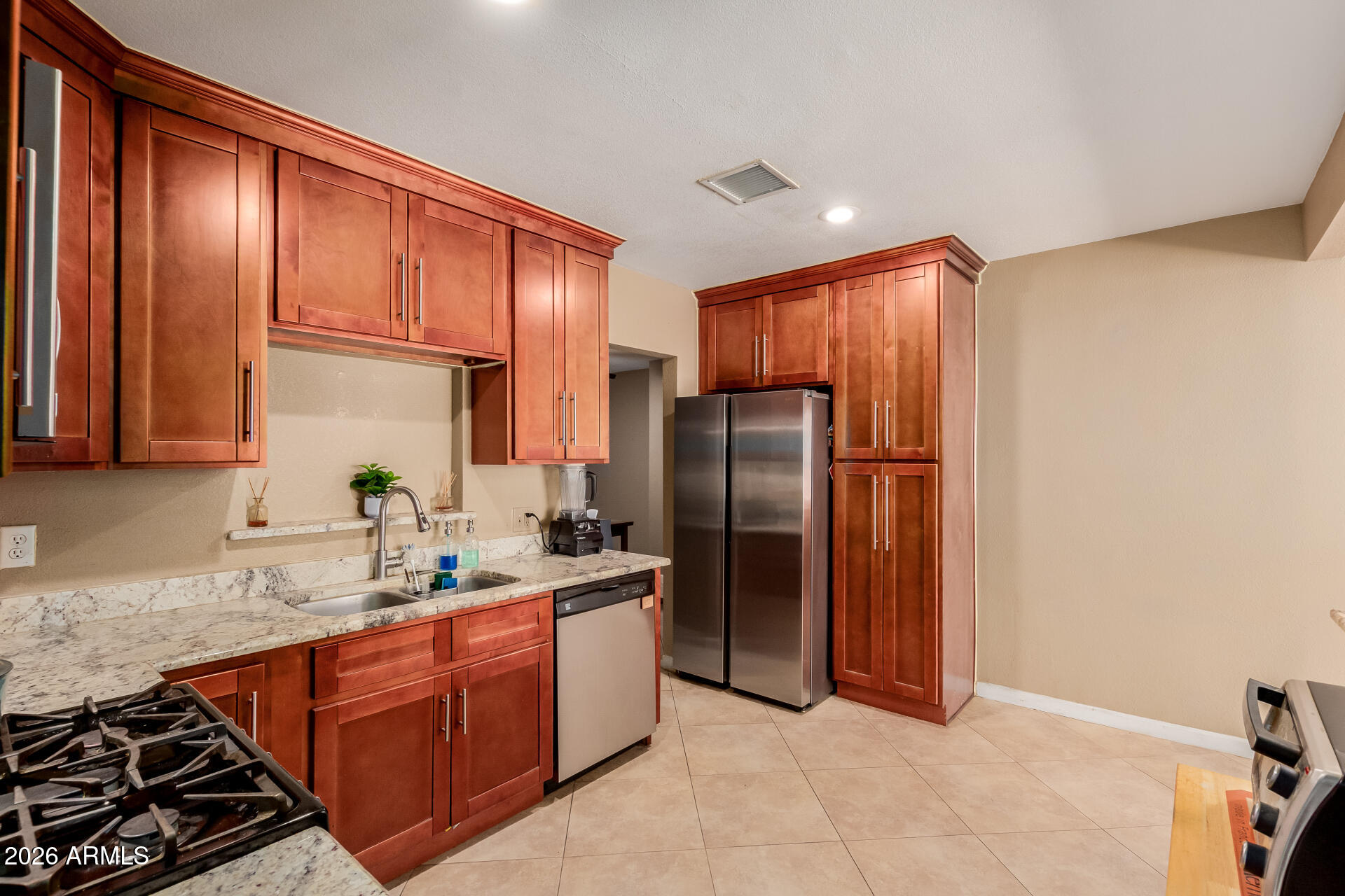 1644 West Sonora Street Phoenix, AZ 85007 - Photo 8 of 29 a kitchen with stainless steel appliances granite countertop a refrigerator and a sink