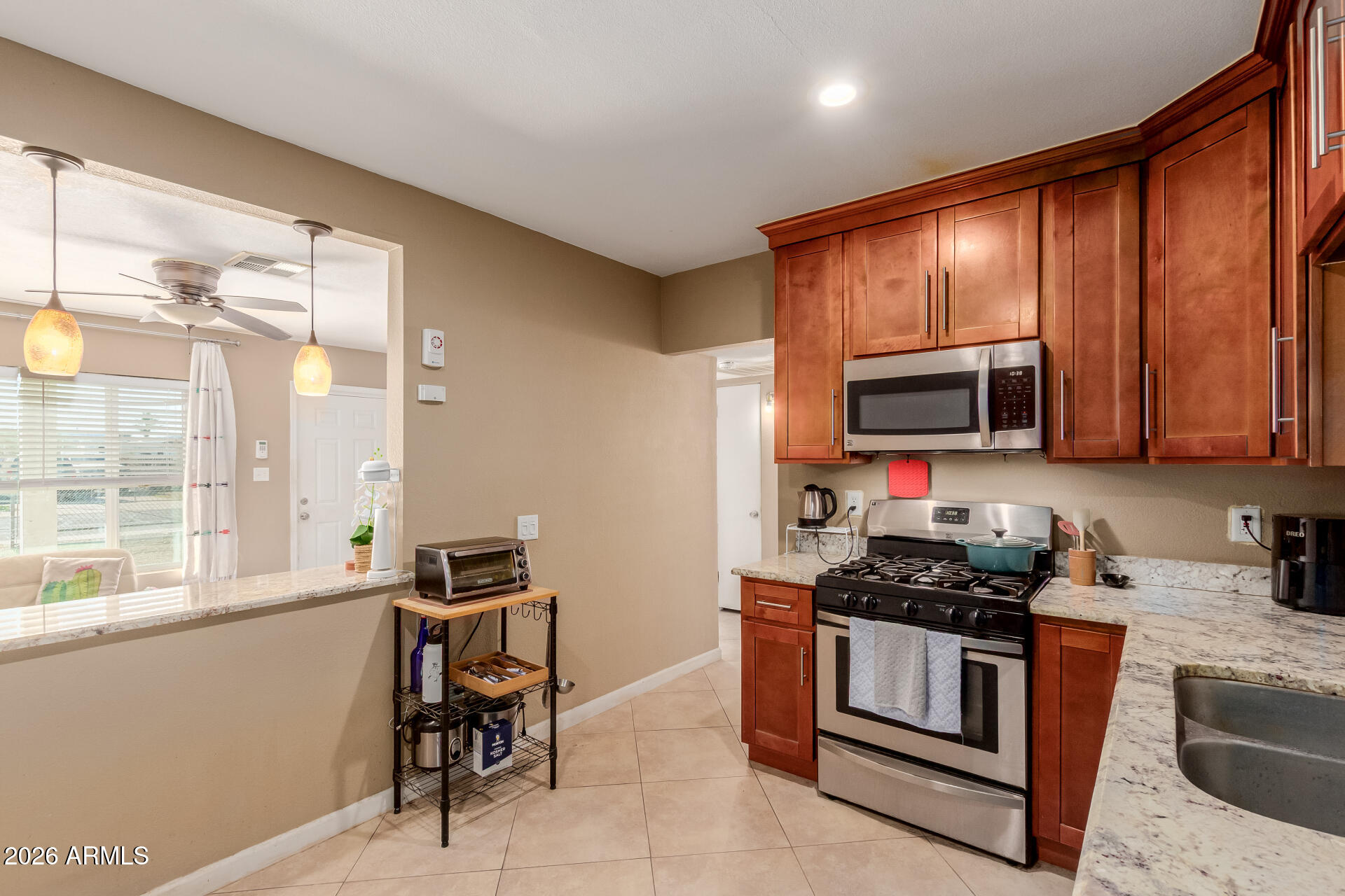 1644 West Sonora Street Phoenix, AZ 85007 - Photo 10 of 29 a kitchen with stainless steel appliances a stove a sink and a microwave