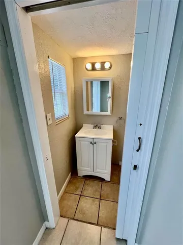a bathroom with a sink a toilet a mirror and vanity