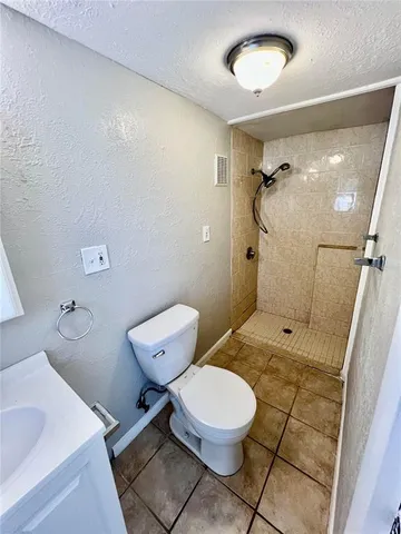 a bathroom with a toilet sink and shower