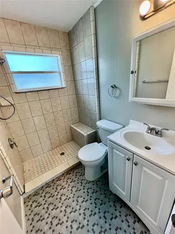 a bathroom with a sink toilet and shower