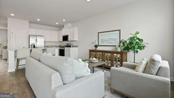 a living room with furniture and a potted plant