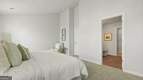 a bedroom with a bed and hallway