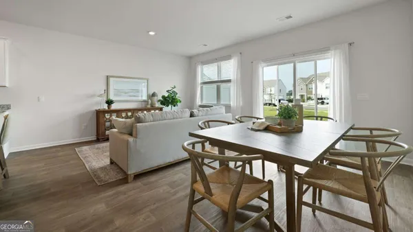a view of a dining room with furniture and wooden floor