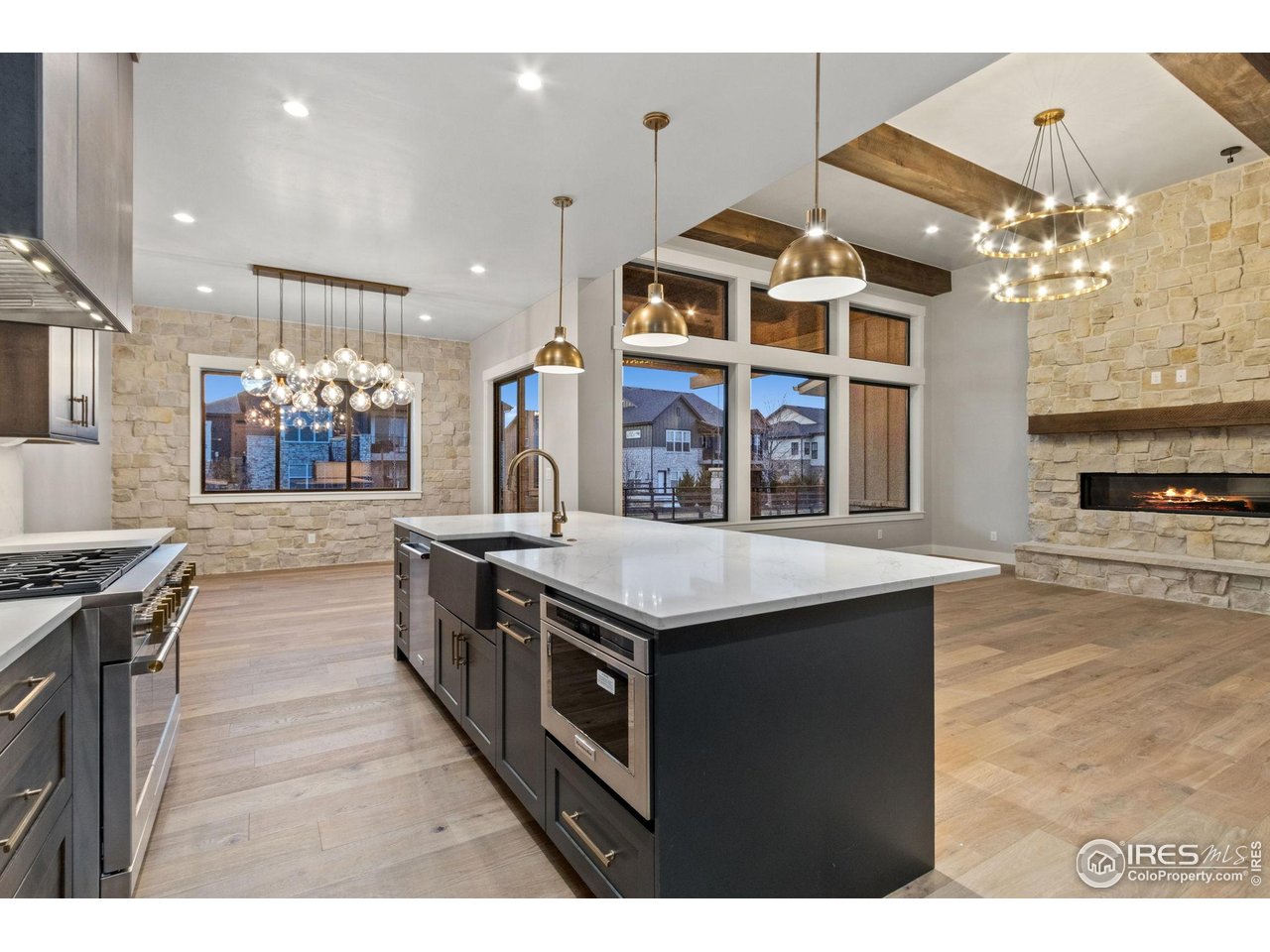 6325 Sanctuary Drive Windsor, CO 80550 - Photo 11 of 42 a kitchen with stainless steel appliances granite countertop a stove and a large cabinets