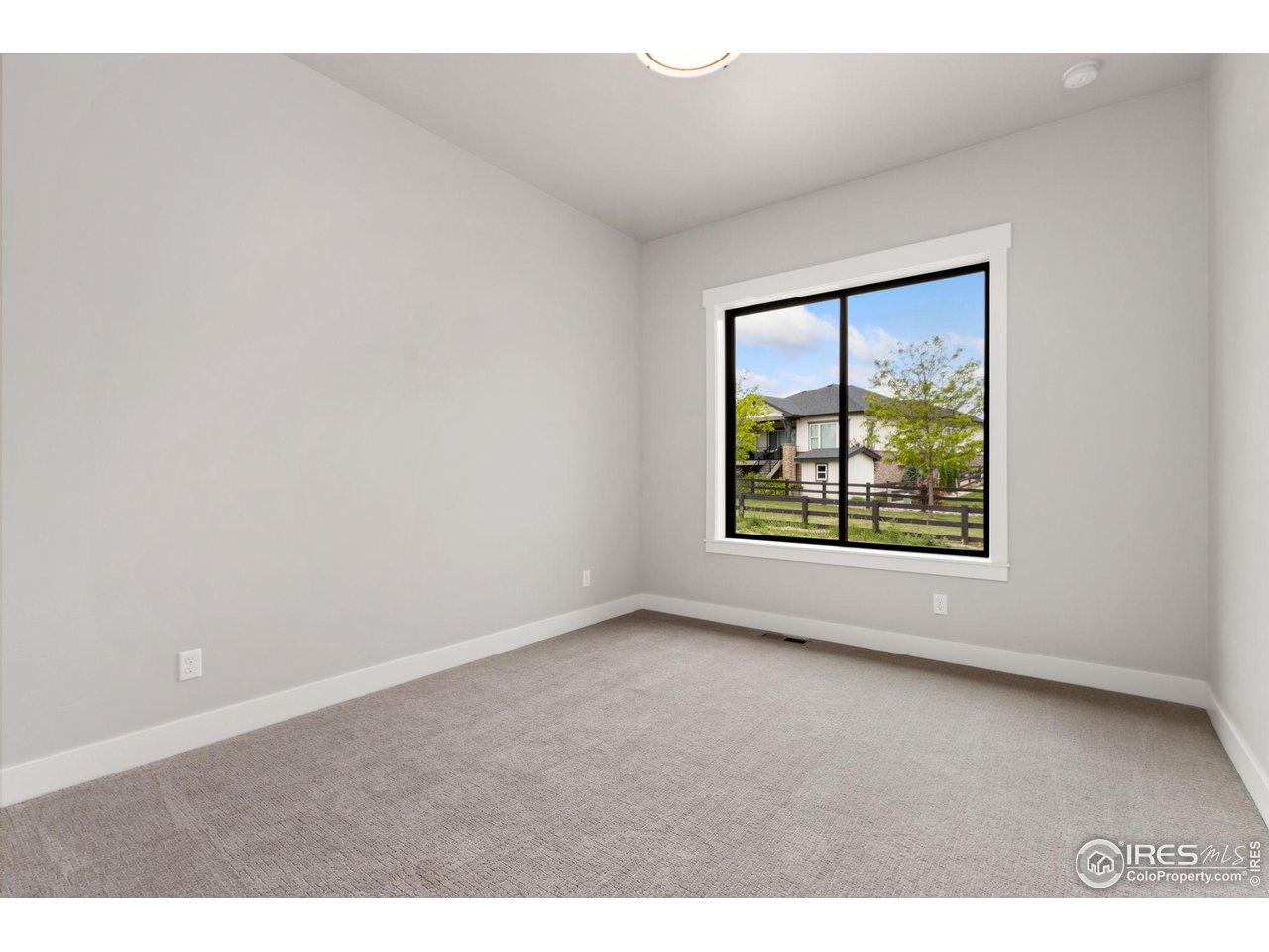6325 Sanctuary Drive Windsor, CO 80550 - Photo 16 of 42 an empty room with windows