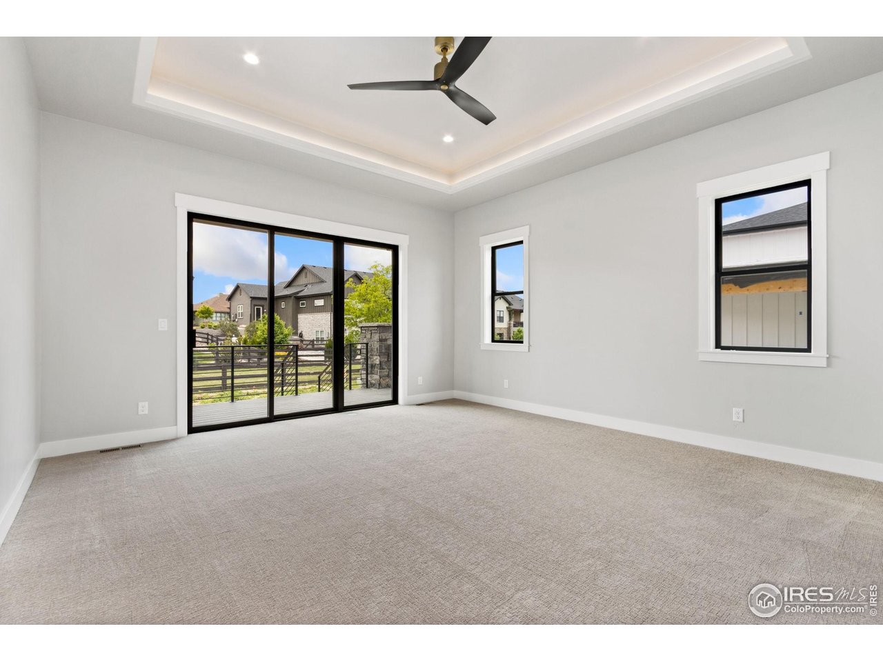 6325 Sanctuary Drive Windsor, CO 80550 - Photo 19 of 42 a view of an empty room with a window and a ceiling fan