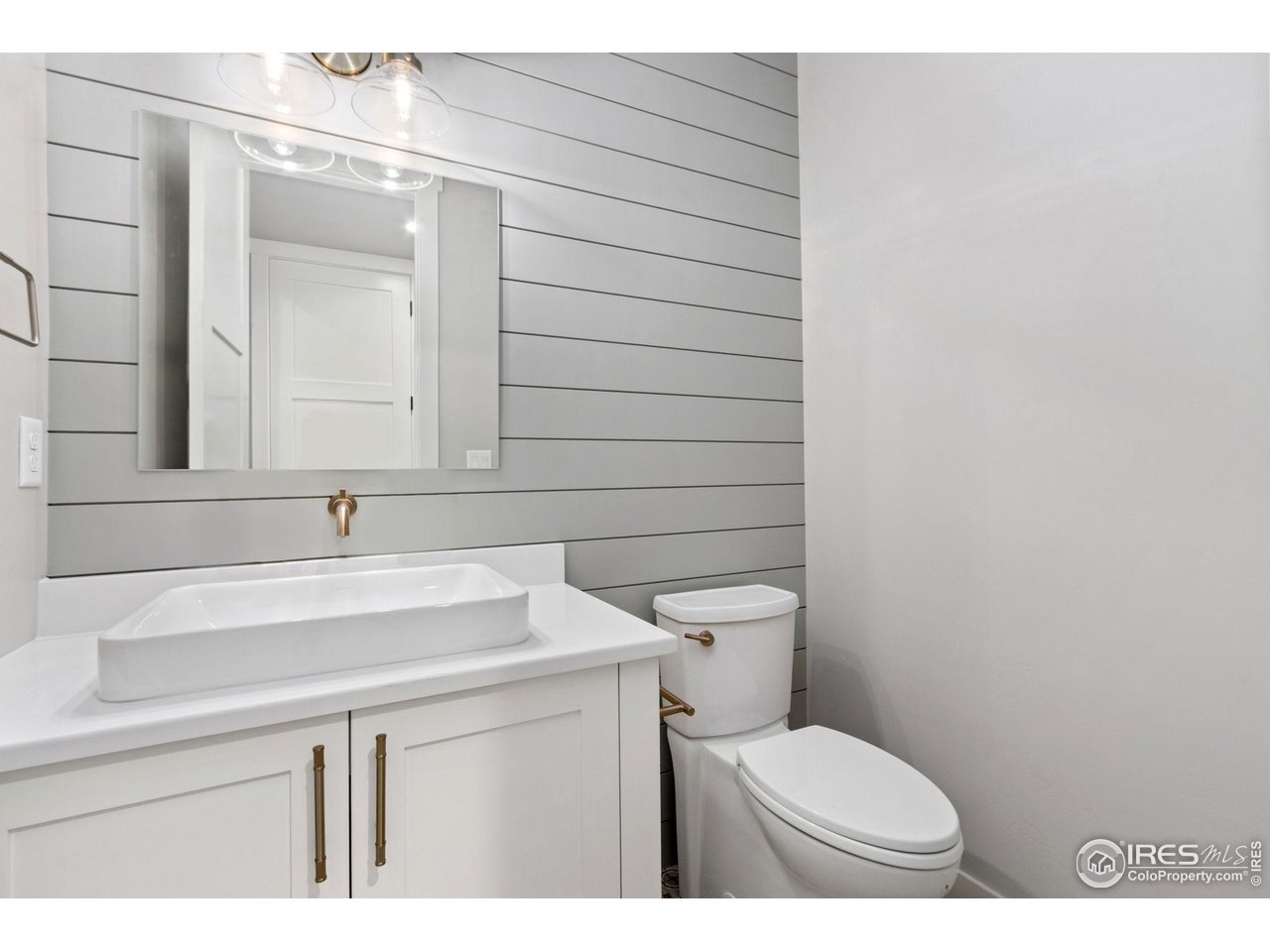 6325 Sanctuary Drive Windsor, CO 80550 - Photo 28 of 42 a bathroom with a toilet a sink and mirror