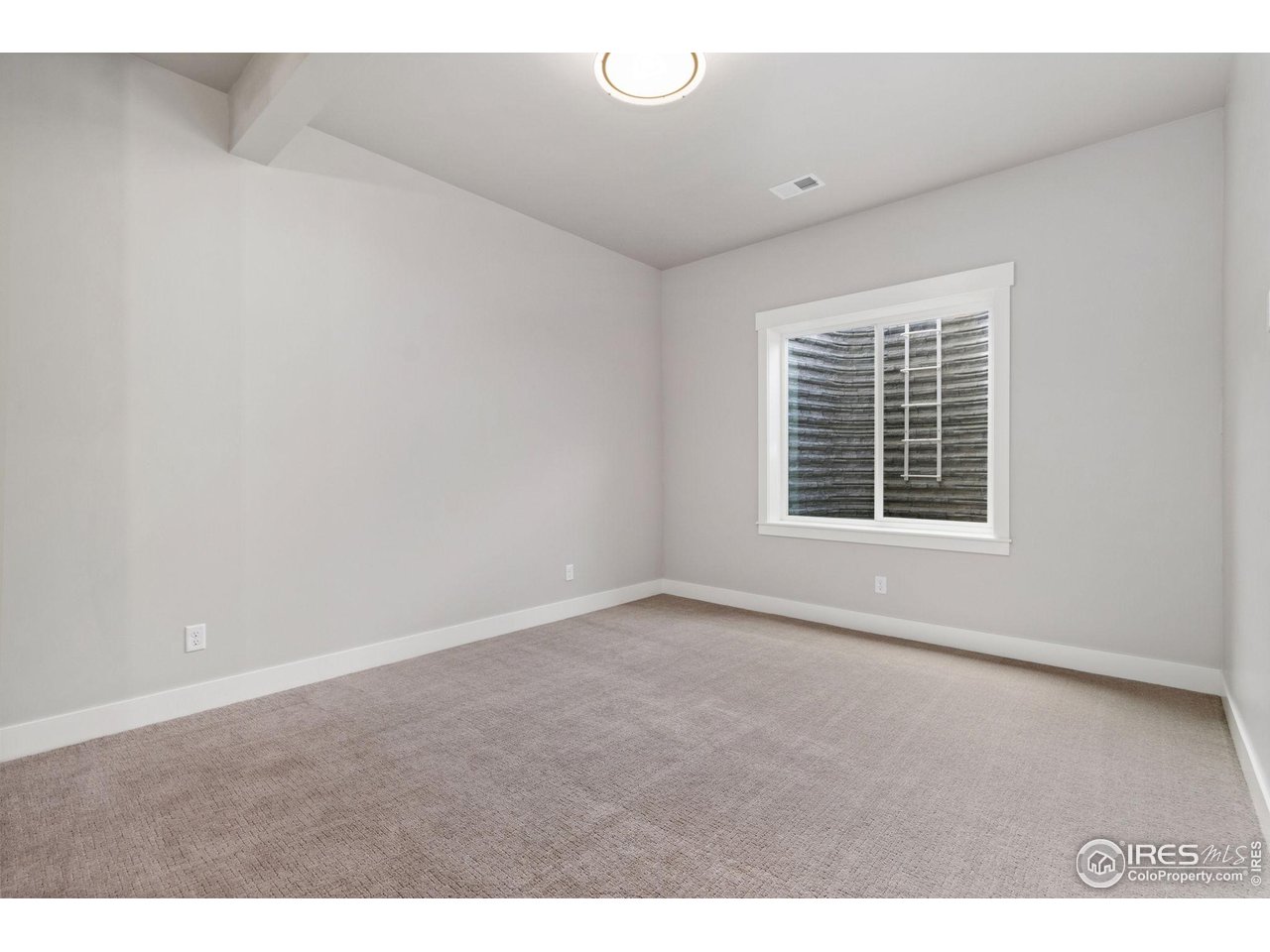 6325 Sanctuary Drive Windsor, CO 80550 - Photo 29 of 42 a view of an empty room with a window