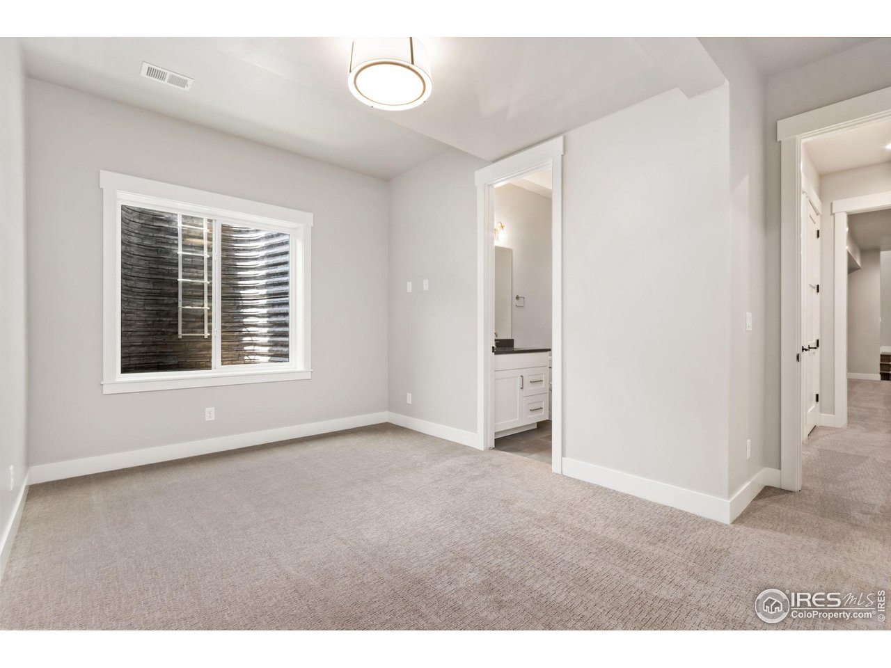 6325 Sanctuary Drive Windsor, CO 80550 - Photo 31 of 42 a view of an empty room with a window