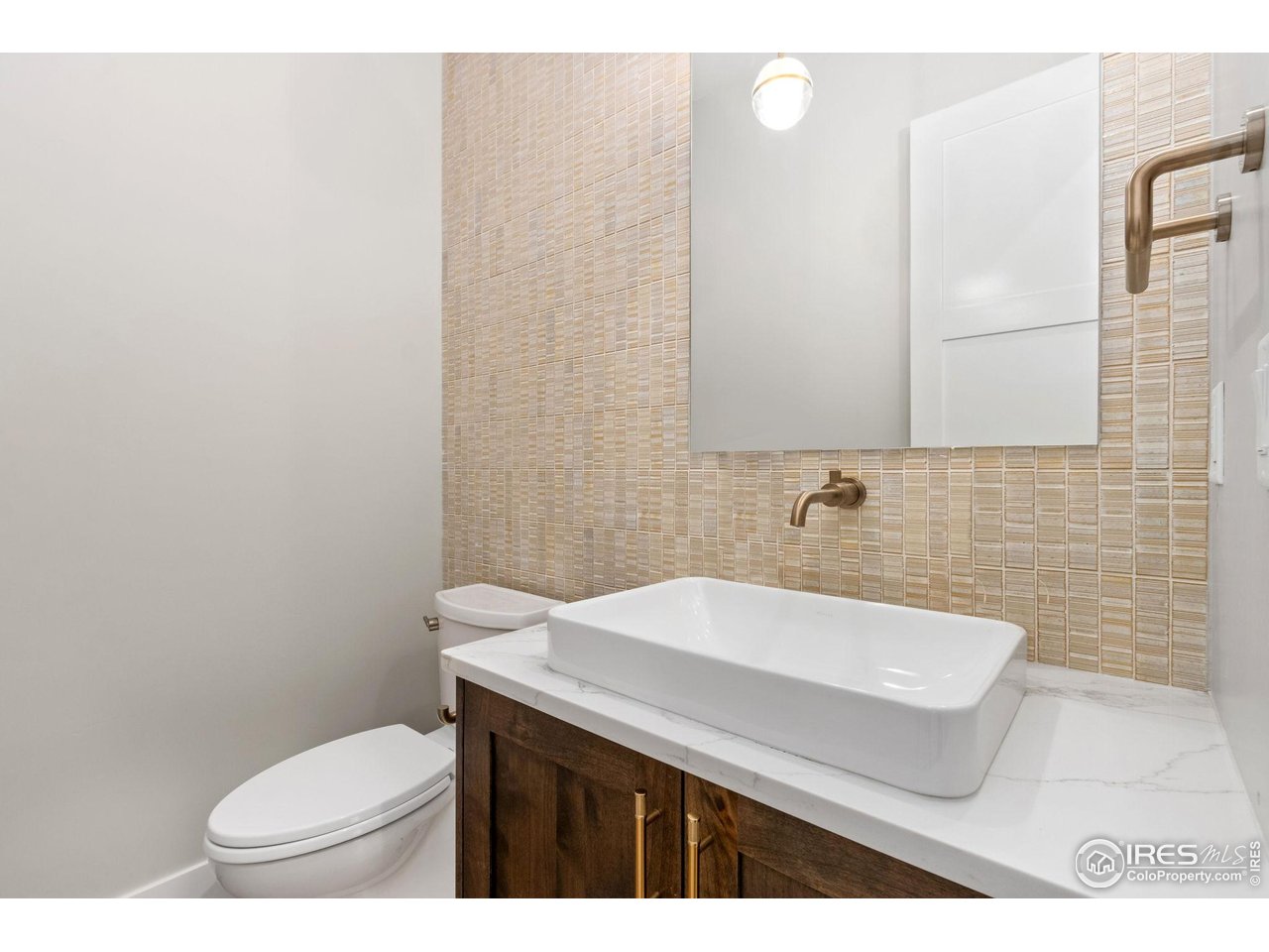 6325 Sanctuary Drive Windsor, CO 80550 - Photo 33 of 42 a bathroom with a sink a toilet and mirror