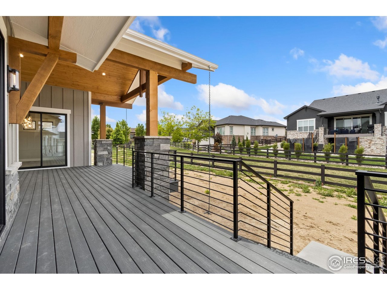 6325 Sanctuary Drive Windsor, CO 80550 - Photo 39 of 42 a view of a balcony with furniture and wooden floor