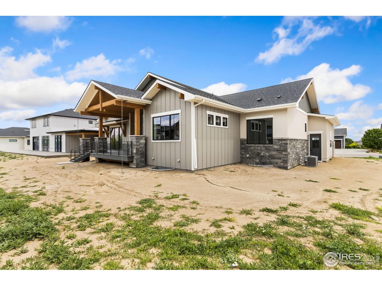 6325 Sanctuary Drive Windsor, CO 80550 - Photo 41 of 42 a big house with a big yard and large trees