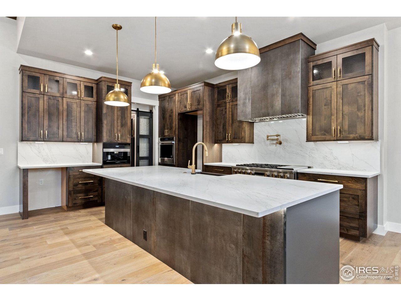6325 Sanctuary Drive Windsor, CO 80550 - Photo 8 of 42 a kitchen with a sink and a refrigerator