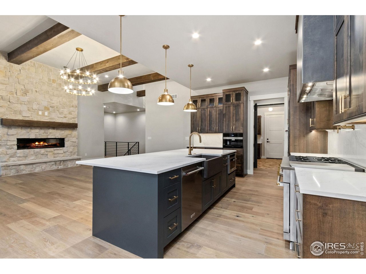 6325 Sanctuary Drive Windsor, CO 80550 - Photo 9 of 42 a kitchen with stainless steel appliances granite countertop a stove a sink and a refrigerator