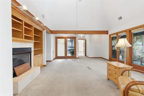 a kitchen with stainless steel appliances granite countertop a stove and a dining table