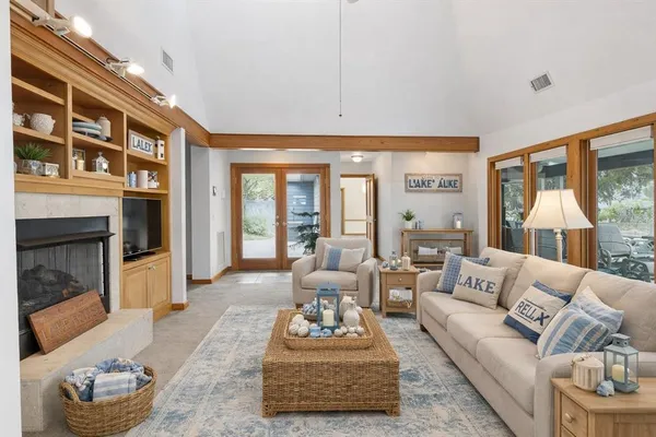 a dining area with furniture and a floor to ceiling window