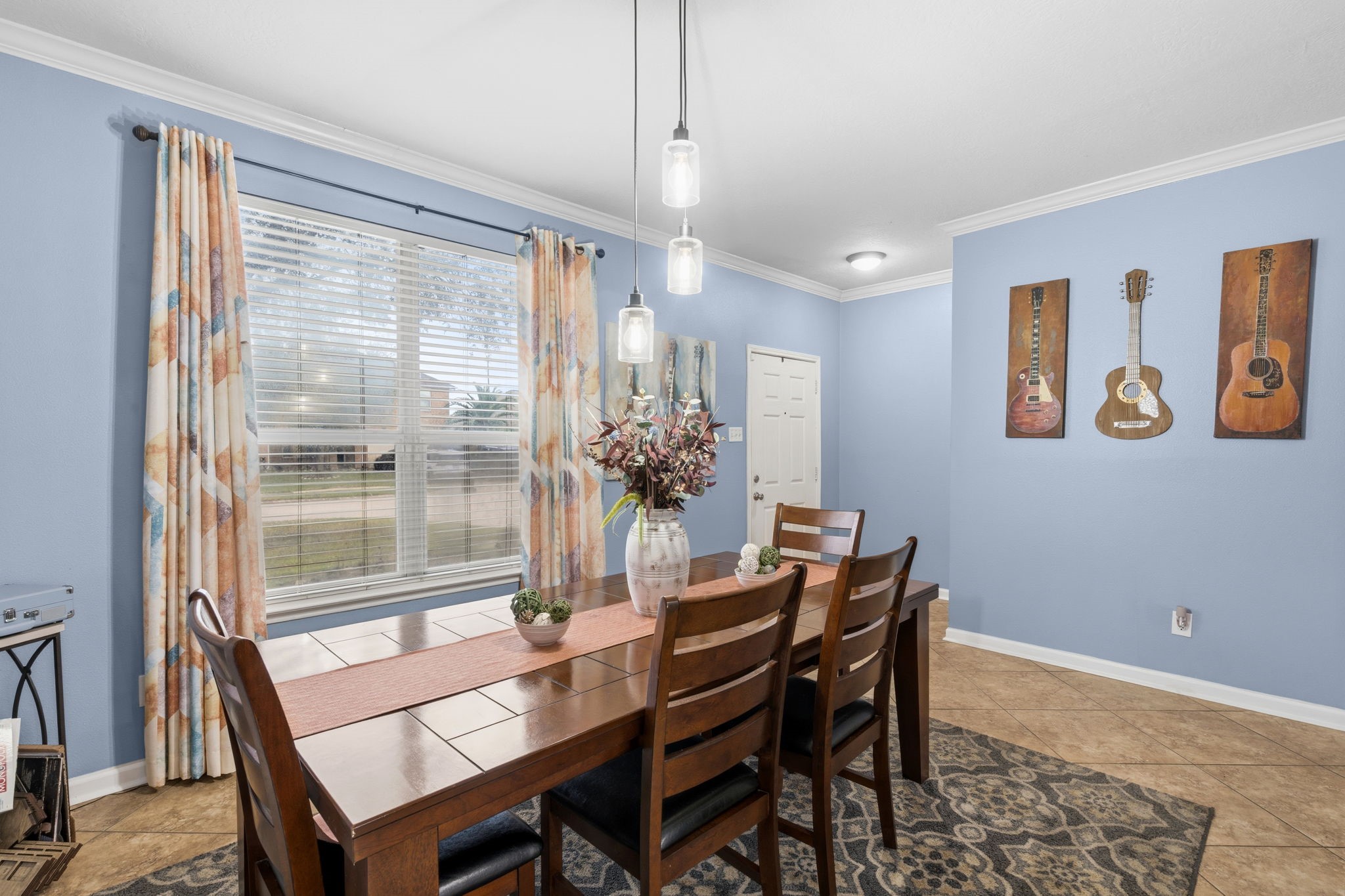 1319 Collier Point Lane Fresno, TX 77545 - Photo 13 of 33 Large windows bathe the dining area in natural light while providing peaceful backyard views, creating a bright and welcoming space for entertaining and daily meals.