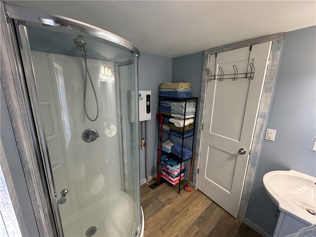 43 Sunset Cove Road Abbeville, SC 29620 - Photo 12 of 41 This clean and functional bathroom offers a compact shower and a modern sink.