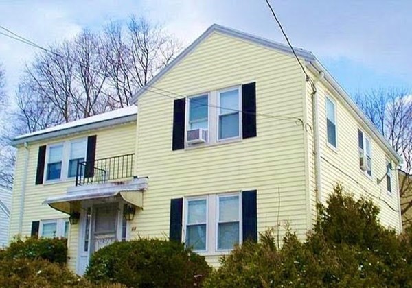 64 Loring Street, Unit 2 Boston, MA 02136 - Photo 1 of 1 a view of a white house with large windows and a small yard