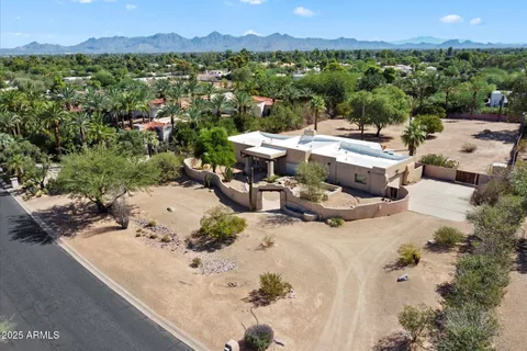 an aerial view of a house with a yard and lake view