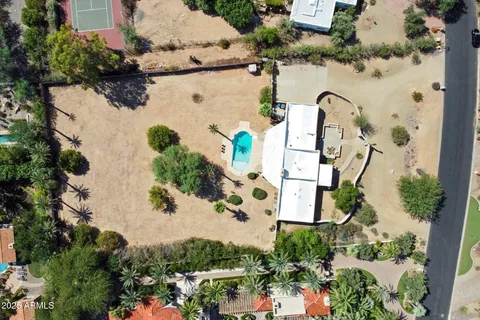 an aerial view of a house with a yard and trees