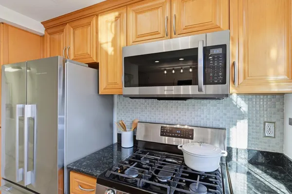 a kitchen with granite countertop a sink and a stove