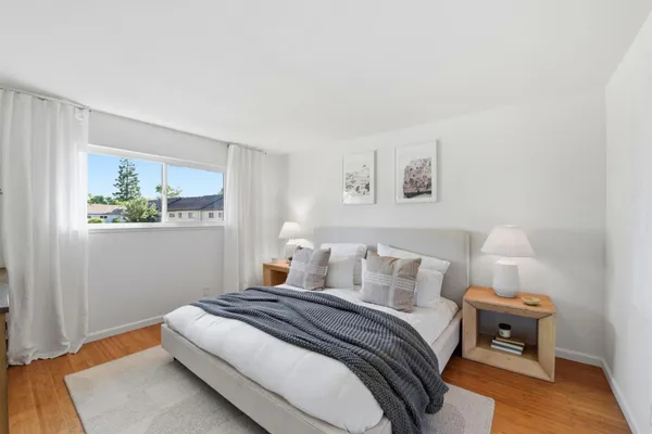 a bedroom with a bed and a night stand