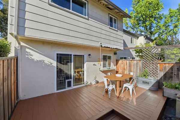 a view of a patio with table and chairs and potted plants