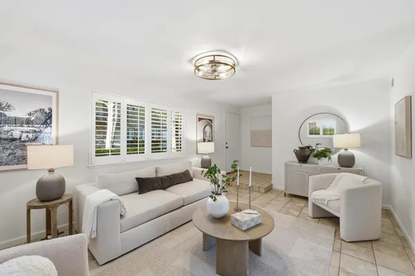 a living room with furniture a window and a table
