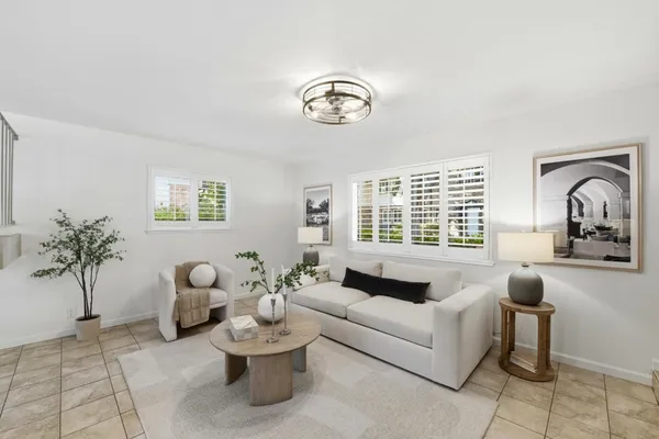 a living room with furniture flowerpot and window