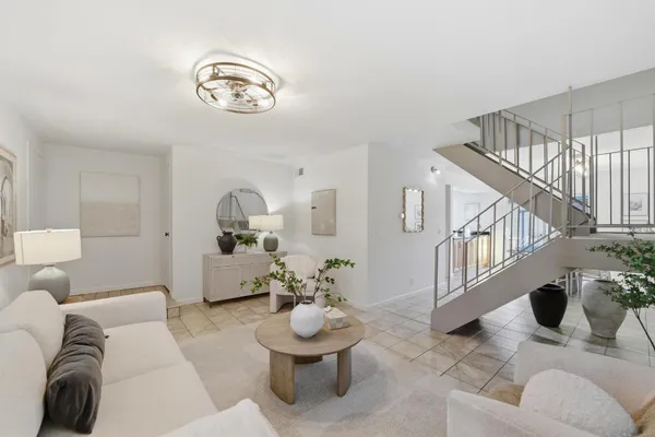 a kitchen with stainless steel appliances a dining table chairs and stove top oven