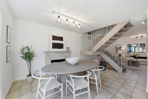 a kitchen with stainless steel appliances granite countertop a sink a stove counter space and a window