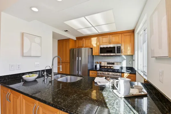 a kitchen with a stove and a refrigerator