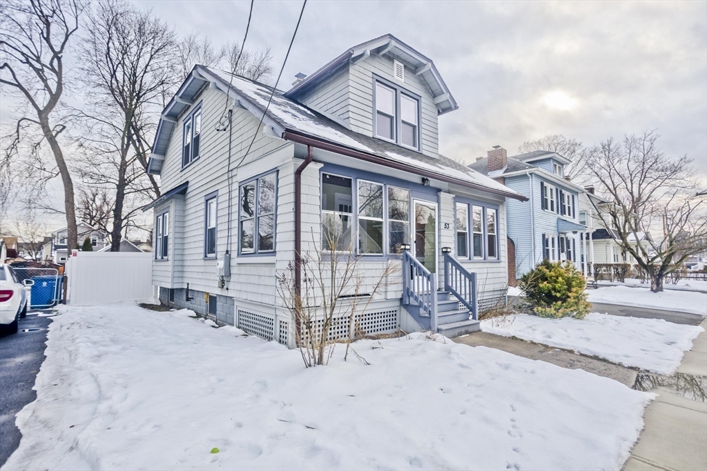 a view of a house with a snow in the yard