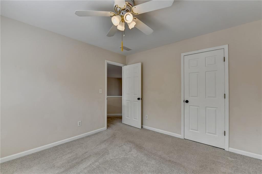 100 Hawnley Trc Northwest Suwanee, GA 30024 - Photo 51 of 58 a view of an empty room and chandelier fan