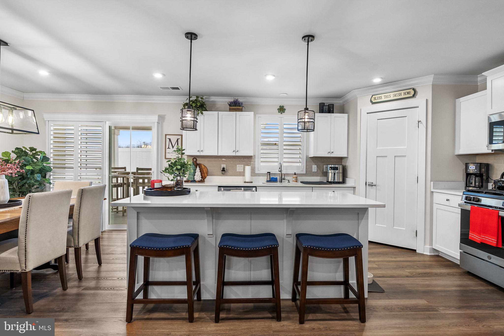 80 Senators Way Berlin, NJ 08009 - Photo 16 of 29 a kitchen with kitchen island granite countertop a table chairs sink and cabinets
