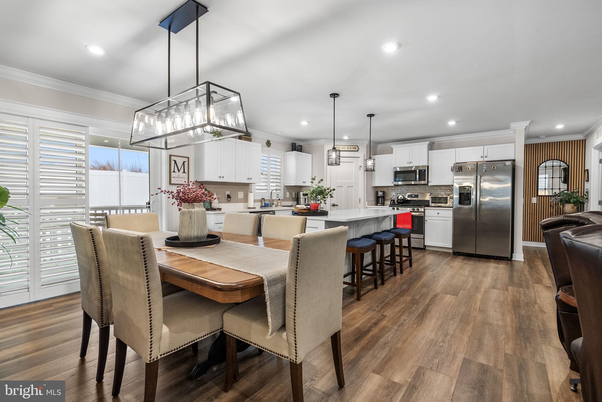 80 Senators Way Berlin, NJ 08009 - Photo 20 of 29 a kitchen with stainless steel appliances kitchen island granite countertop a table chairs and a refrigerator