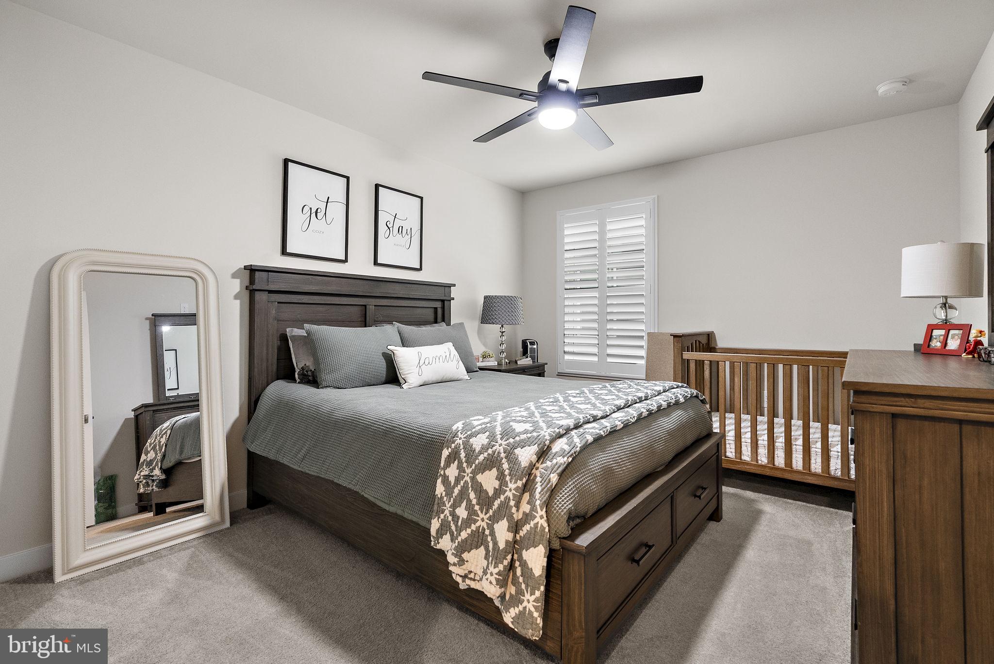 80 Senators Way Berlin, NJ 08009 - Photo 9 of 29 a bedroom with a bed and a chandelier