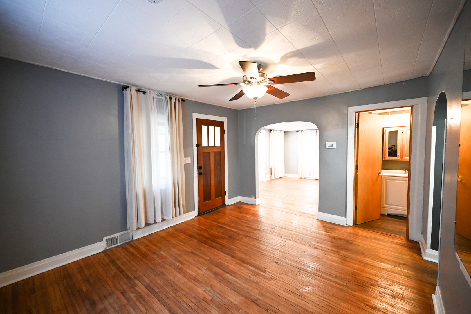 219 South 7th Street DeKalb, IL 60115 - Photo 8 of 30 a view of an empty room with window and wooden floor