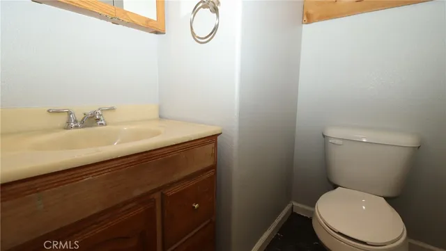 a white toilet sitting next to a bathroom sink