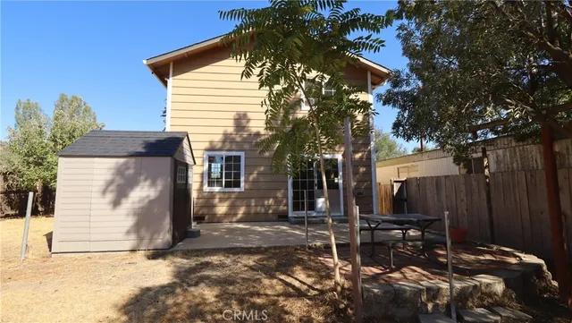 a view of a chairs and tables in the back yard of the house