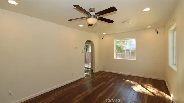 wooden floor in an empty room with a window