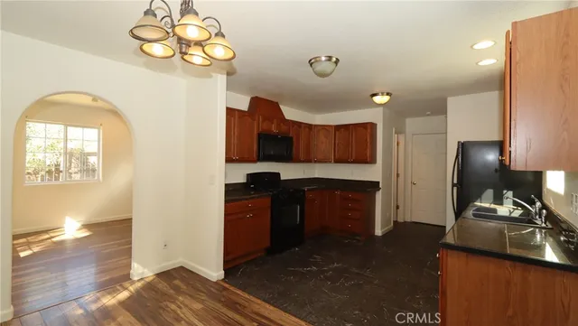 a kitchen with a refrigerator and a stove top oven