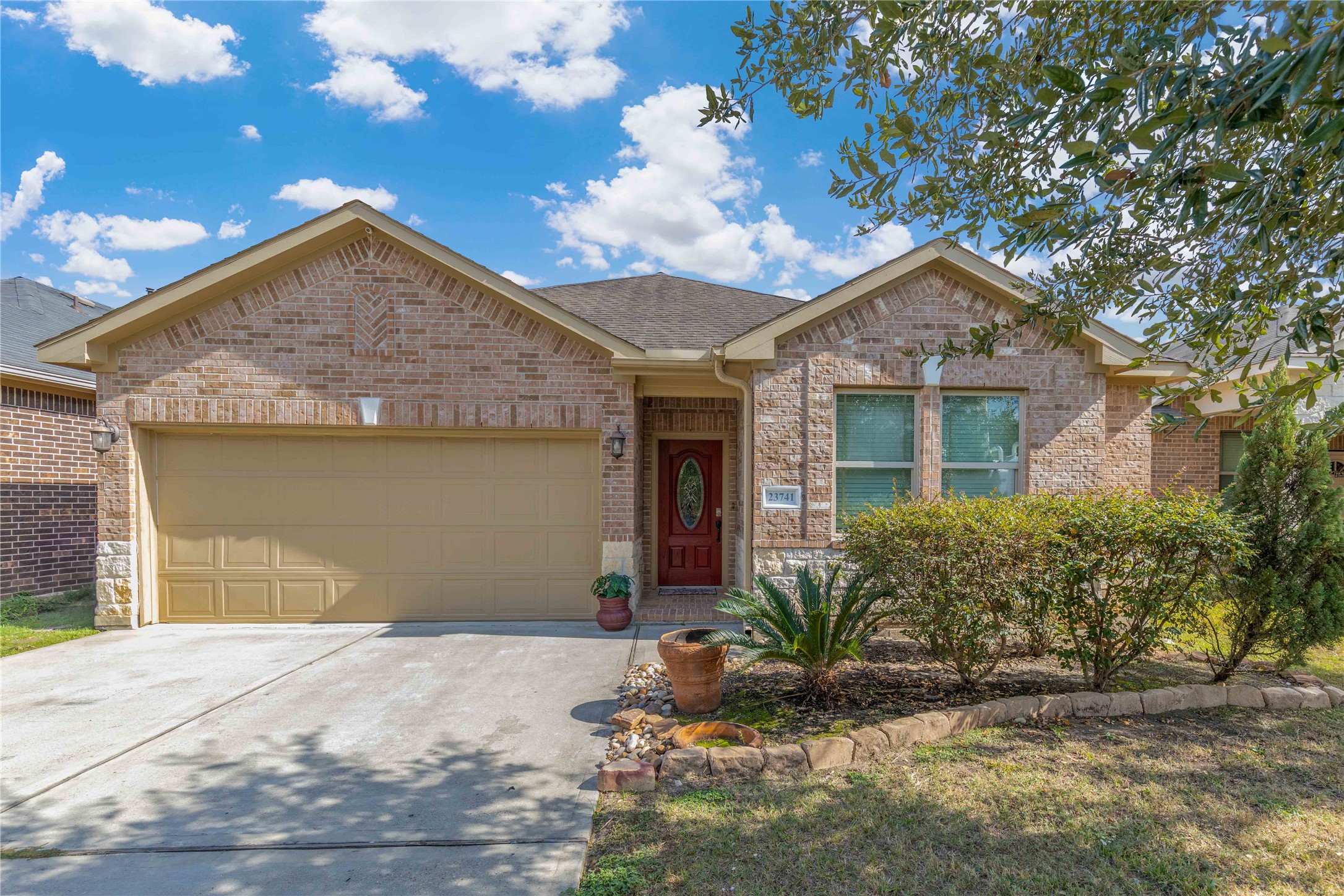 23741 Briar Tree Drive Porter, TX 77365 - Photo 1 of 36 a front view of a house with a yard and garage