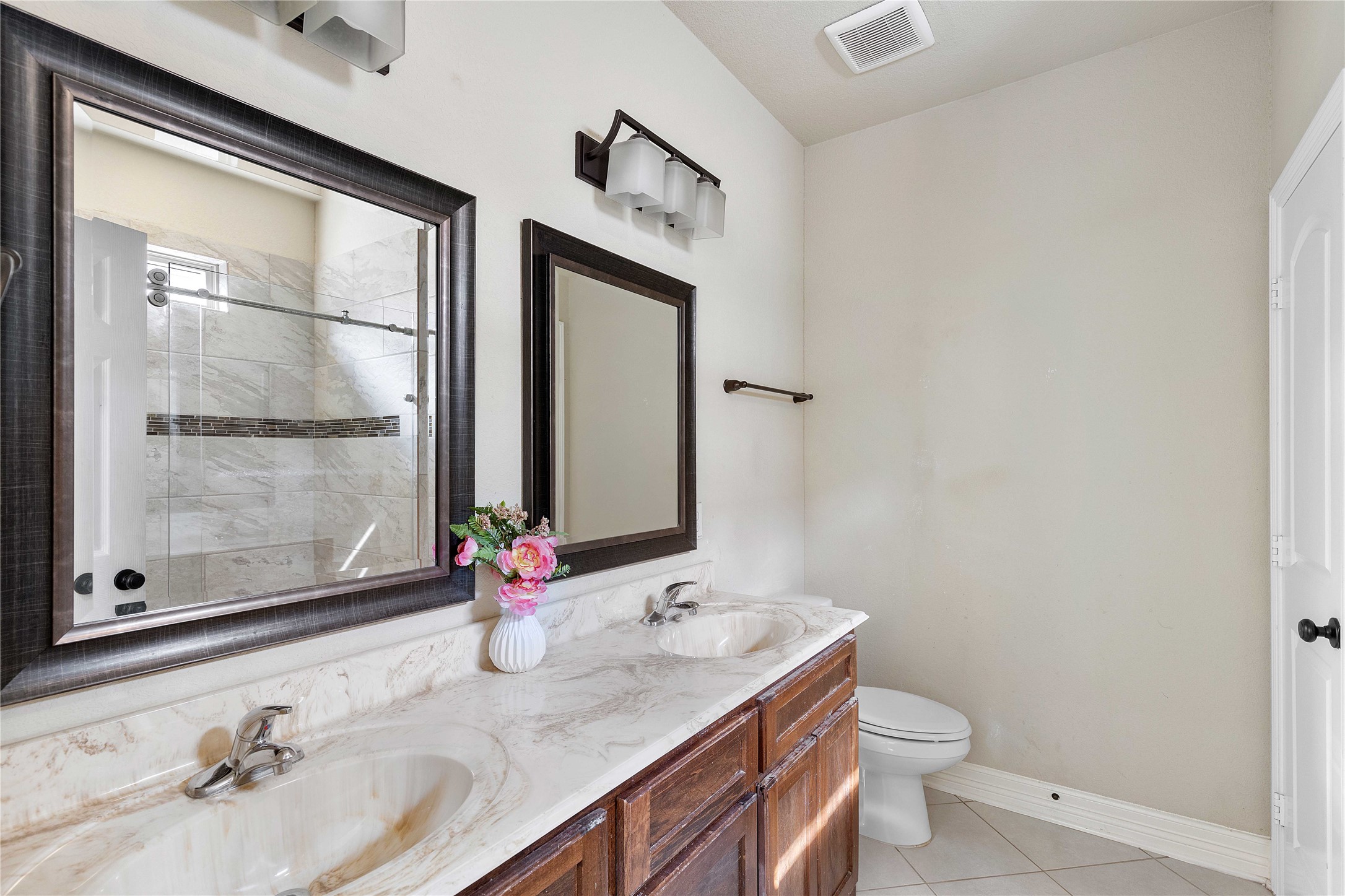 23741 Briar Tree Drive Porter, TX 77365 - Photo 21 of 36 a bathroom with a granite countertop sink a toilet and a mirror