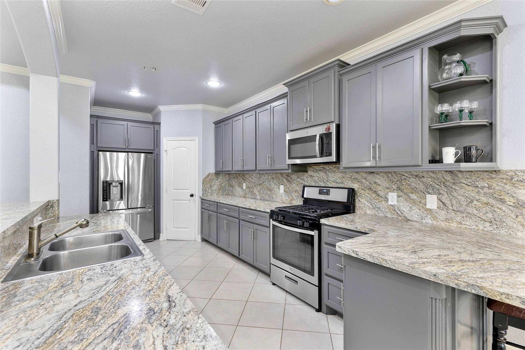 23741 Briar Tree Drive Porter, TX 77365 - Photo 4 of 36 a kitchen with stainless steel appliances granite countertop a sink stove and refrigerator