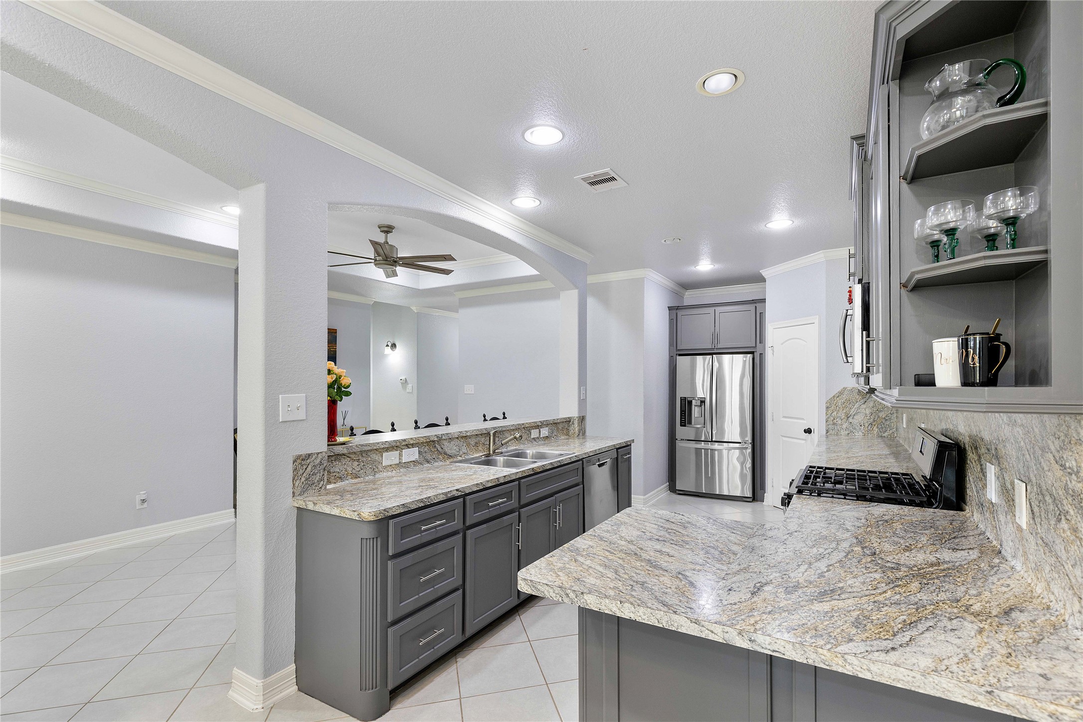 23741 Briar Tree Drive Porter, TX 77365 - Photo 6 of 36 a kitchen with stainless steel appliances granite countertop a sink stove and refrigerator
